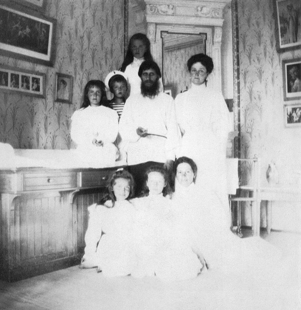 Empress Alexandra Feodorovna with Rasputin, her children and a governess.