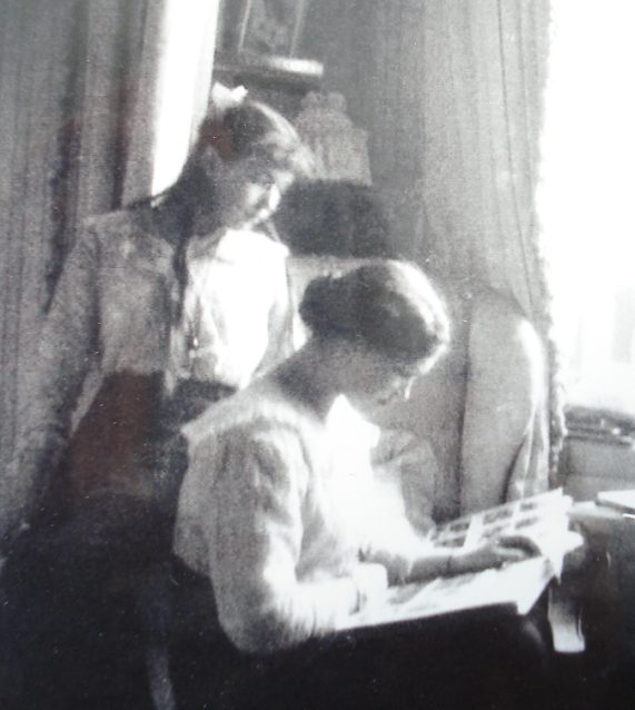 Grand Duchesses Olga and Anastasia looking at a photo album