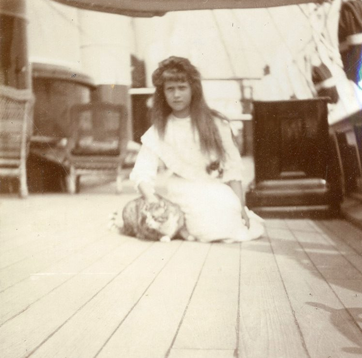 Anastsasia Romanov with Olga's cat Vaska on the imperial yacht The Standart. 