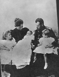 Nicholas II and Alexandra Feodorovna holding infant Maria, with her two elder sisters, Olga and Tatiana looking on.