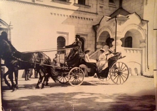 Grand Duchesses Maria and Anastasia Romanov in a carriage with their mother Empress Alexandra in front of their infirmary in Tsarskoe Selo. This very rare photo is from the archives of Igor Sikorsky II and used with his permission.