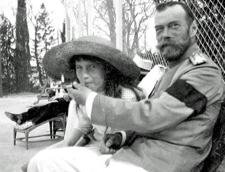 Tsar Nicholas II with his daughter Grand Duchess Anastasia. The Tsar is giving his daughter a drag of his cigarette. 