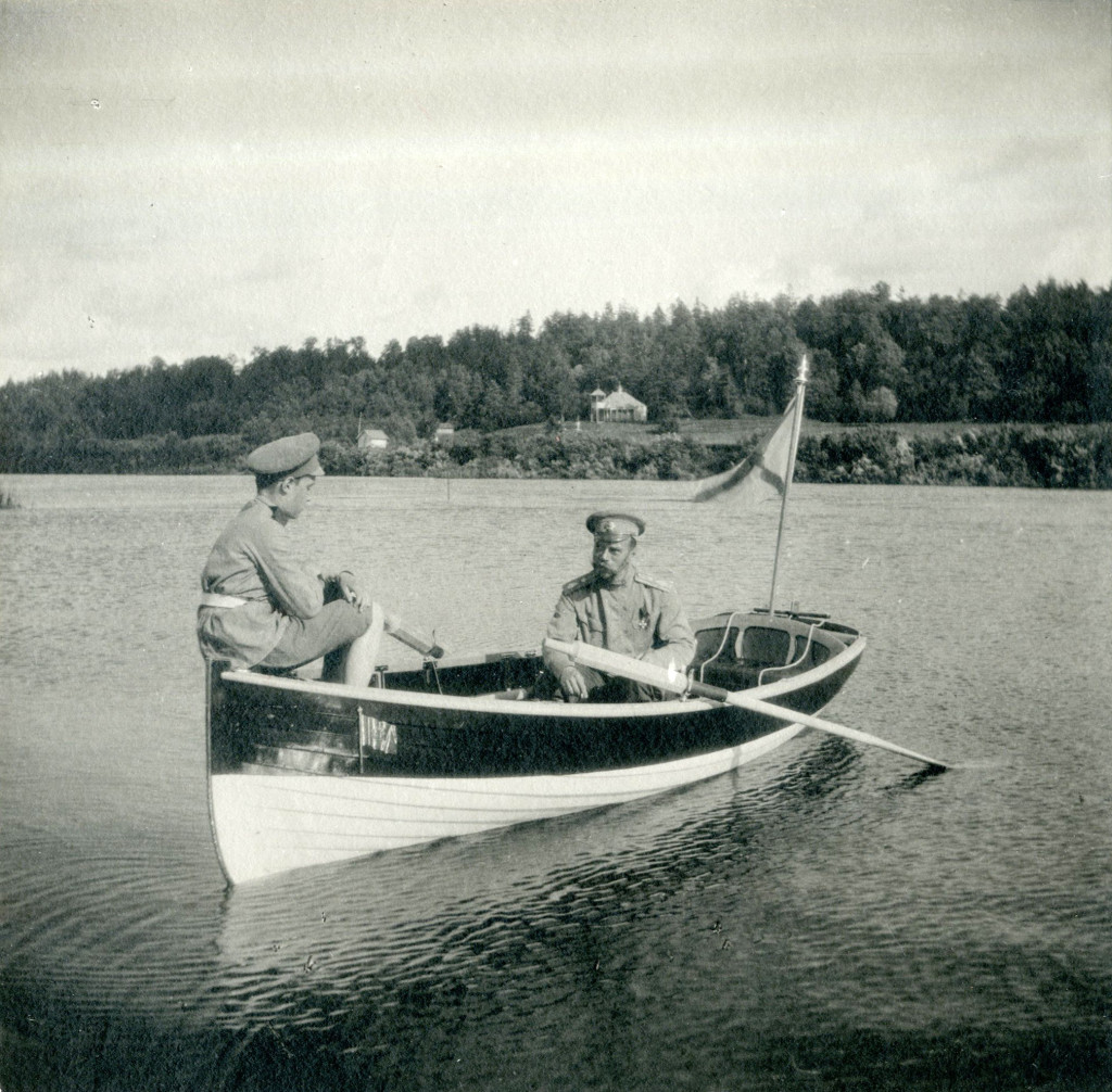 Tsar Nicholas II and his son Tsarevich Alexei rowing a boat on the Dnepr River.