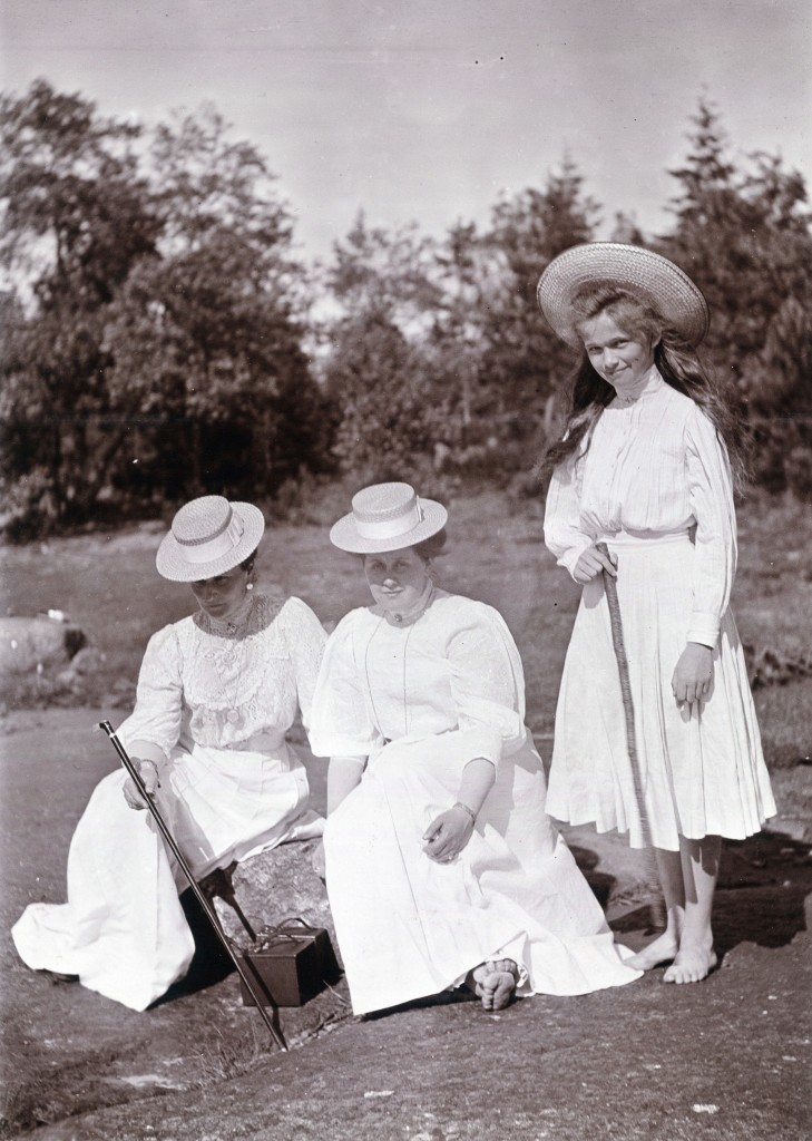 Empress Alexandra Feodorovna and Lady in waiting Anna Vyrubova (sitting) as well as Grand Duchess Olga Nikolaevna (standing) at Finnish skerries, Paatio island. Note the two box cameras between the empress and the lady in waiting.