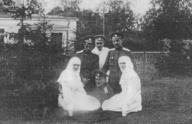 Sister Olga Romanov and Sister Tatiana Romanov posing with the wounded officers . "Mitya": Dmitri Shakh-Bagov is on the left. 